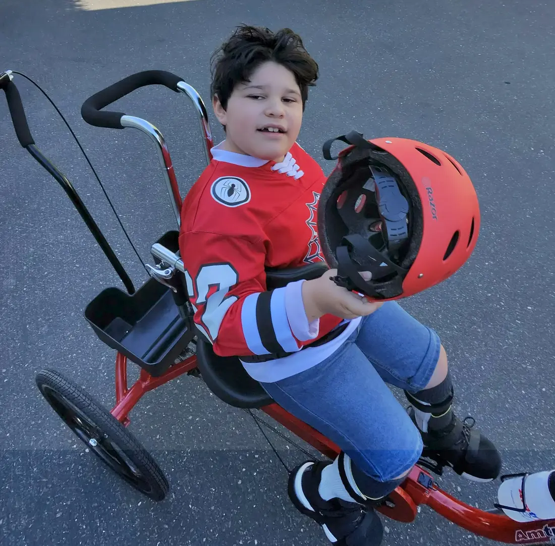 Lukas with his new red Paceline 20 adaptive Tryke.